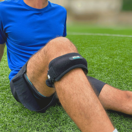 Resting on the field with the knee strap